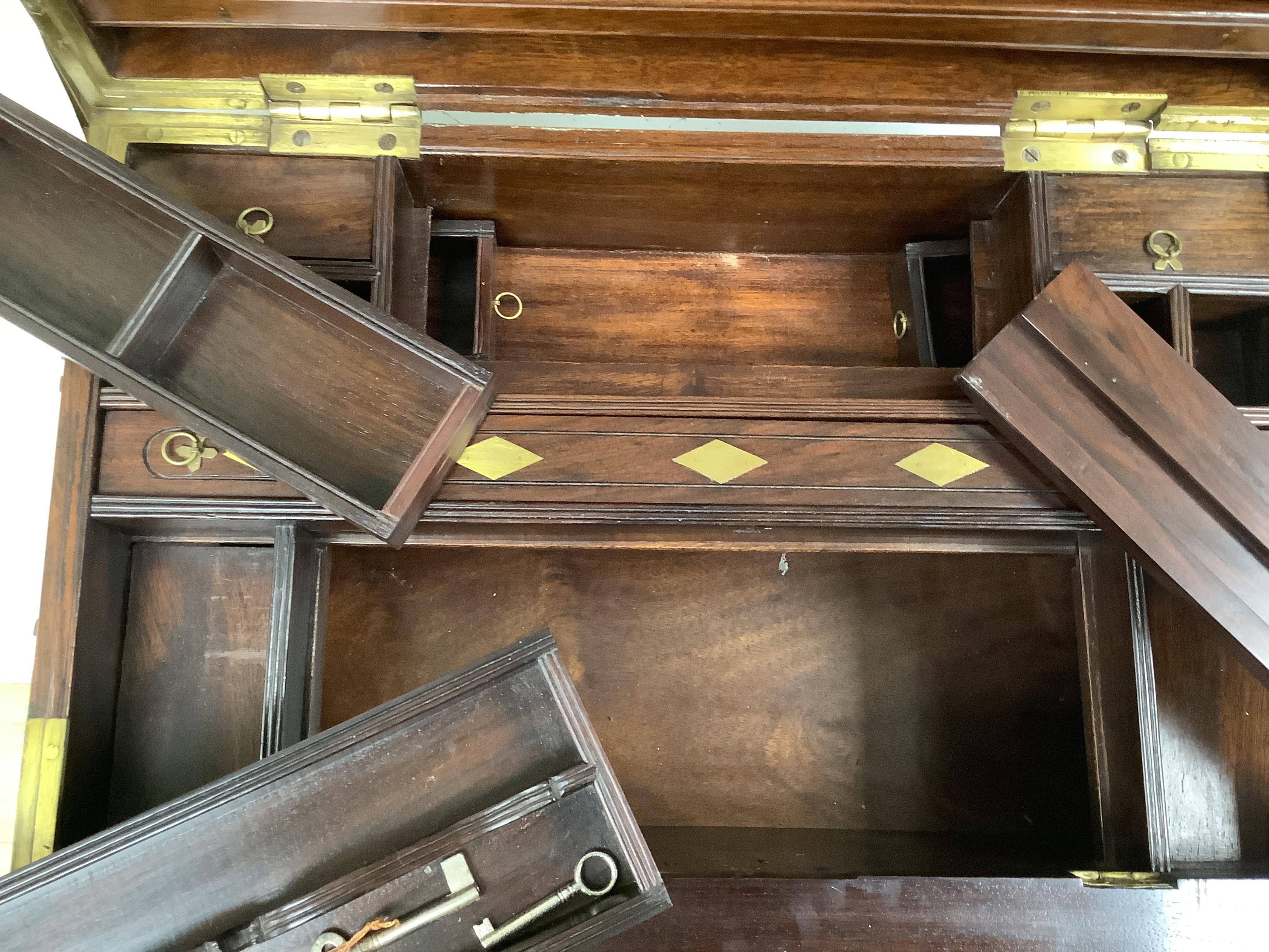 A 1920’s Anglo Indian brass mounted rosewood chest with fitted interior and key, 48cm wide. Condition - fair/good